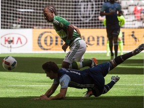 Portland Timbers' Darren Mattocks (21) fights for the ball against Vancouver Whitecaps' Nicolas Mezquida (11) during first half of Saturday's game at B.C. Place. It was Mattocks' first game in Vancouver since being traded to Portland.