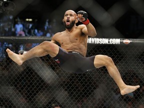 Demetrious Johnson celebrates after defeating Henry Cejudo in a flyweight championship mixed martial arts bout at UFC 197, Saturday, April 23, 2016, in Las Vegas.