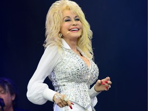 FILE -- In this June 29, 2014 file photo, U.S singer Dolly Parton performs at Glastonbury music festival, in England. NBC is in business with famed musician, Parton. The network has closed a deal for a series of TV movies based on her songs, stories and "inspired life,"  NBC Entertainment Chairman Bob Greenblatt said Friday, Jan. 16, 2015.