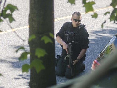 Two men are in custody and a woman — who was found naked by police — is being treated in hospital following a bizarre standoff at a downtown Vancouver cellphone shop.