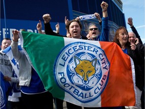 Leicester city football fans celebrate outside the King Power Stadium in Leicester, central England, on Tuesday, after the team won the English Premier League title on Monday. — Getty Images