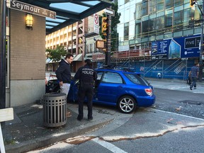 A car has crashed into a building in downtown Vancouver Tuesday morning. A silver SUV was also involved in the collision, and sits in the intersection of Pender and Seymour with the front end smashed.