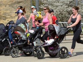 Jessica Butt, Kristen Nagel, Beki Dries, trainer Bernice Robinson, and Sarah Denomy, l-r, jog with their babies in strollers in Ivey Park in London, Ontario on Thursday May 5, 2016. The women were taking part in a program called Power Stroller designed for new moms 4-6 weeks postpartum. The first week starts with simple activities that gradually increase in difficulty and athleticism each week. The program also helps create social networks for the new moms while preventing postpartum depression. MORRIS LAMONT  / THE LONDON FREE PRESS / POSTMEDIA NETWORK