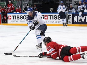 Patrik Laine of Finland  plays the puck against Mark Stone of Canada during the 2016 IIHF World Championship gold medal game.