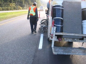 BC government crews paint road lines on a provincial highway.