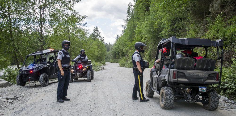 From left, Mission RCMP Const. James Mason, Insp. Ted De Jager and Const. Alyn Beerda on patrol on Burma Road, the stretch of dusty gravel that leads to the Stave Lake mudflats. Police are aiming this summer to crack down on the reckless behaviour on and around the mudflats. 