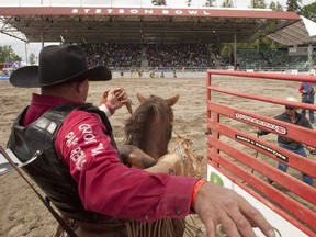 A behind-the-chute view of a saddle bronc rider competing in the 70th annual Cloverdale Rodeo in Surrey Saturday. The four-day event drew more than 100,000 people over the May long weekend.