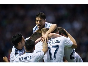 Vancouver Whitecaps' Nicolas Mezquida, top, jumps on teammates as they celebrate a goal against Dallas April 23. The Uruguayan earned from coach Carl Robinson for his play in that game and last Saturday's 3-2 road loss versus New York City FC.