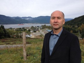 Haisla chief councillor Ellis Ross with a view of his community in the background in the fall of 2014, when the local economy was booming with a ramp up for LNG projects and Rio Tinto's modernization of its aluminum smelter in Kitimat. The Haisla community is now in a tough waiting period as LNG projects are in limbo because of a slump in prices and an uncertain global economy. Gordon Hoekstra/Vancouver Sun [PNG Merlin Archive]