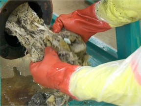 Metro Vancouver employees work to 'de-rag' a clog at a Port Moody pump station.