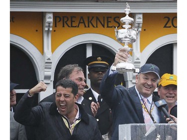 Principal partner of Big Chief Racing Matt Bryan, right, celebrates with other team members after Exaggerator with Kent Desormeaux aboard won  the 141st Preakness Stakes horse race at Pimlico Race Course, Saturday, May 21, 2016, in Baltimore.