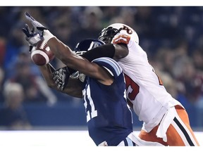 Toronto Argonauts' Vidal Hazelton, left, attempts a pass as B.C. Lions' Steven Clarke interferes during first half CFL football action in Toronto, on Friday, Oct. 30, 2015. Clarke returns to the Lions after a 'shock' release by the Tennessee Titans.