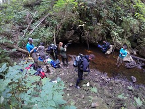 Scuba divers prepare to enter a karst cave on the central coast of the Great Bear Rainforest.