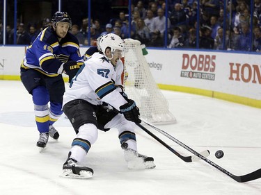 San Jose Sharks center Tommy Wingels (57) chases the puck against St. Louis Blues defenseman Jay Bouwmeester (19) during the third period in Game 5 of the NHL hockey Stanley Cup Western Conference finals, Monday, May 23, 2016, in St. Louis. (AP Photo/Jeff Roberson)  ORG XMIT: MOJR127