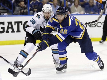 St. Louis Blues center Paul Stastny (26) chases the puck against San Jose Sharks center Logan Couture (39) during the second period in Game 5 of the NHL hockey Stanley Cup Western Conference finals, Monday, May 23, 2016, in St. Louis. (AP Photo/Jeff Roberson)  ORG XMIT: MOJR120