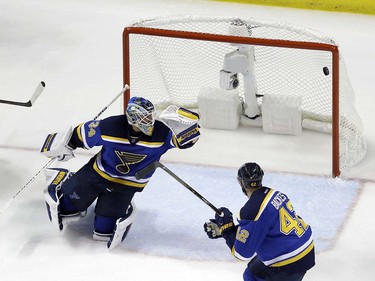 The puck shot by San Jose Sharks center Joe Pavelski (8) flies past St. Louis Blues goalie Jake Allen (34) for a goal during the second goal of during the second period in Game 5 of the NHL hockey Stanley Cup Western Conference finals, Monday, May 23, 2016, in St. Louis. (AP Photo/Jeff Roberson)  ORG XMIT: MOJR123