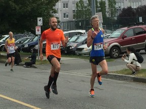 Dominic Geelle, right, and Vasilii Trofimchuk sprint to the finish in Sunday morning's Oasis Shaughnessy 8K, while Michael Foster trails.
