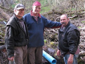 Steele Springs Waterworks District chair Brian Upper (left) with trustees Loyde Berkholtz and Mike Paull installing a pipeline. The waterworks supplies about 52 households and 150 residents in the township of Spallumcheen with drinking water.