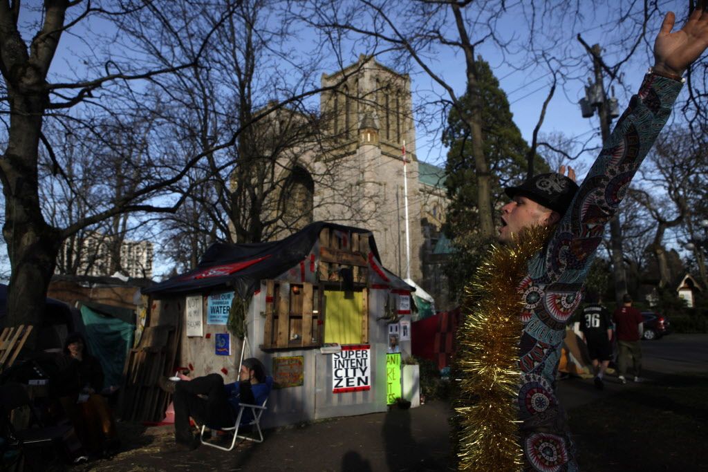 A camp resident celebrates at the homeless camp, also known as InTent City, during a block party in February. 