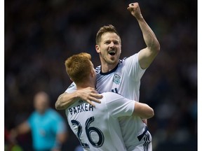Vancouver Whitecaps' Jordan Harvey, right, and Tim Parker celebrate Harvey's goal against FC Dallas during the second half of an MLS soccer game in Vancouver, B.C., on Saturday April 23, 2016.