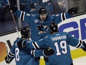 San Jose Sharks' Tomas Hertl (48) celebrates his goal with teammates Joe Thornton (19) and Joe Pavelski (8) during the third period in Game 3 of the NHL hockey Stanley Cup Western Conference finals against the St. Louis Blues on Thursday, May 19, 2016, in San Jose, Calif. San Jose won 3-0.