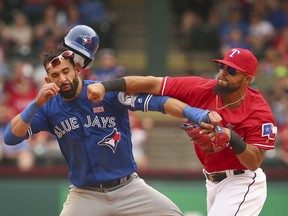 Toronto Blue Jays base runner Jose Bautista takes it on the chin from Texas Rangers second baseman Rougned Odor on Sunday during their heated American League game.