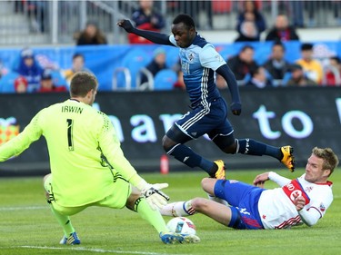 Toronto FC defender Damien Perquis (24) and Toronto FC goalkeeper Clint Irwin (1) defend against Vancouver Whitecaps forward Kekuta Manneh (23) during the first half of MLS action in Toronto on Saturday, May 14, 2016.