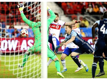 Toronto FC defender Drew Moor (3) gets a ball past Vancouver Whitecaps goalkeeper David Ousted (1) during the second half of MLS action in Toronto on Saturday, May 14, 2016.