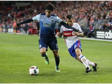 Toronto FC forward Sebastian Giovinco (10) battles with Vancouver Whitecaps midfielder Christian Bolanos (7) during the second half of MLS action in Toronto on Saturday, May 14, 2016.