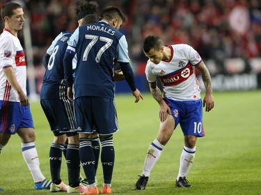 Toronto FC forward Sebastian Giovinco (10) shows an injury to Vancouver Whitecaps Fraser Aird and Whitecaps midfielder Pedro Morales (77) after Aird was given a yellow card on the play during the second half of MLS action in Toronto on Saturday, May 14, 2016.