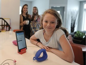 Bella Hood, a young girl with cystic fibrosis, demonstrates a mobile app that will be part of a game that helps CF kids with their breathing exercises.