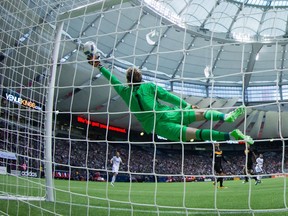 Houston Dynamo goalkeeper Tyler Deric dives but is beaten by Vancouver Whitecaps' Octavio Rivero for a goal during the second half of an MLS soccer game in Vancouver, B.C., on Saturday May 28, 2016. - CP