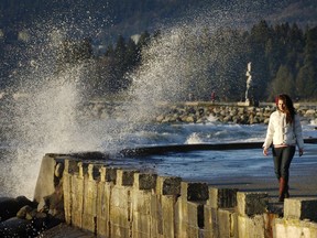 People living along British Columbia’s southern coast are being warned to brace for windy weather. In this file photo, a women walks the Sunset Beach Seawall in the wind.