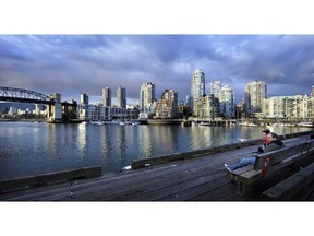 A couple overlooks Vancouver's waterfront at False Creek.