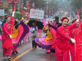 Participants in the Chinese New Year Parade through Chinatown in Vancouver.