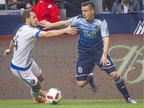 VANCOUVER, BC: March 6, 2016 -- Whitecaps Fraser Aird, right battles for the ball with Montreal Impact Harry Shipp, left  during the first half of a regular-season MLS match at BC Place Stadium in Vancouver, B.C. Sunday March 6, 2016.  (photo by Ric Ernst / PNG)  (Story by sports)  TRAX #: 00042053A & 00042053B [PNG Merlin Archive]