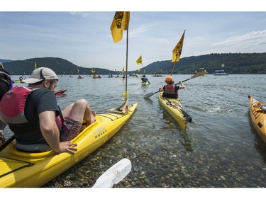 Kayakers prepare to cross Burrard Inlet from Cate's Park in North Vancouver as climate change activists surrounded the Kinder Morgan marine terminal  on land and water in Burnaby, BC. May 14, 2016.