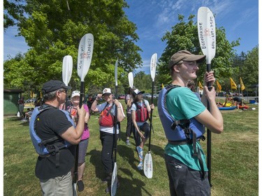 Kayakers prepare to cross Burrard Inlet from Cate's Park in North Vancouver as climate change activists surrounded the Kinder Morgan marine terminal  on land and water in Burnaby, BC. May 14, 2016.