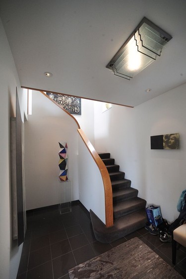 The staircase to the second storey. The light fixture was designed by architect Ross Lort.