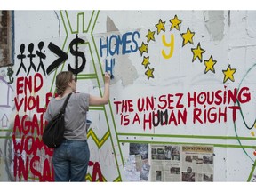 Activists and residents concerned with the housing crisis in the Downtown Eastside take part in a "paint-in" in a spare lot slated for development on W. Hastings Street in Vancouver.