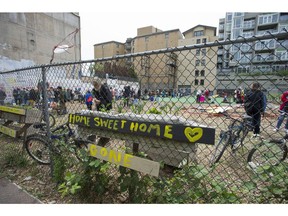 Housing activists and area residents concerned with the housing crisis in the Downtown Eastside take part in a 'paint-in' to protest the lack of affordable housing, in a spare lot slated for development on W. Hastings Street in Vancouver in May 2016.