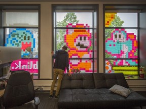 Nathan Nutley stands inside the window of the Blink agency on West Hastings Street in Vancouver on Thursday. Arlen Redekop/PNG