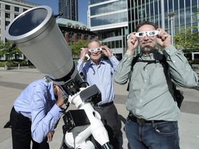 Astronomy enthusiasts view the planet Mercury as it passes in front of the sun for the first time in a decade.