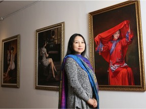 Cecilia Aisin-Gioro, artist and director in her fine art gallery. She stands before the oil on canvas named 'The Bride,' depicting her lifting her red veil.