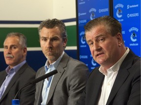 Vancouver Canucks management (from the left): coach Willie Desjarins, president Trevor Linden and GM Jim Benning will pick fifth in June's NHL Entry Draft. Benning admitted he was disappointed with the results of Saturday's draft lottery. PNG FILE PHOTO