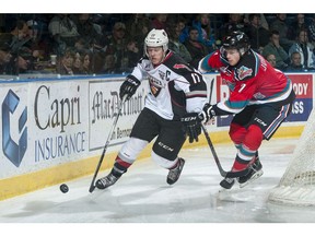 Lucas Johansen of Kelowna Rockets, right, checks Vancouver Giants star Tyler Benson last November. Benson was a projected first-round pick at the start of the season but health problems have dropped his rankings for the NHL Draft June 24-25.
