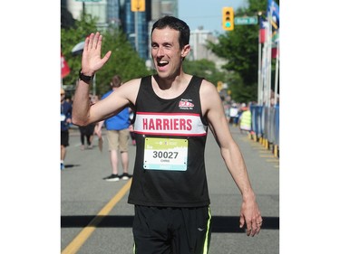 John Halldorson crosses the finish line in first place for 8km in the BMO Vancouver marathon in Vancouver, BC., May 1, 2016.
