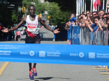 Daniel Kipkoech crosses the finish line in first place in the BMO Vancouver Marathon in Vancouver, BC., May 1, 2016.