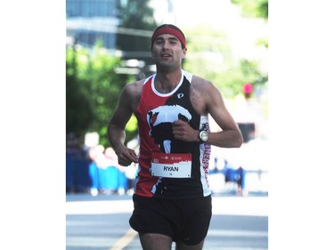 Ryan Day crosses the finish line in third place in the BMO Vancouver marathon in Vancouver, BC., May 1, 2016.