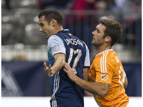 Whitecaps defender Andrew Jacobson keeps Will Bruin away from the ball the last time the Caps hosted the Houston Dynamo, a 1-0 Vancouver win in March.